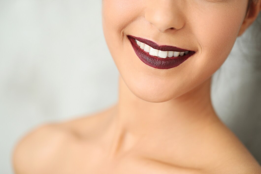 woman-smiling-with-dark-red-lips_144627-23796